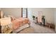 Bedroom with pink accents and plush bedding at 140 Racer St, Bennett, CO 80102