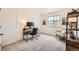 Bedroom with a carpeted floor used as a bright home office at 140 Racer St, Bennett, CO 80102
