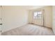 Neutral bedroom with carpeted floors and natural light from the window at 140 Racer St, Bennett, CO 80102