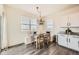 Dining nook adjacent to the kitchen with modern chandelier and bench seating at 140 Racer St, Bennett, CO 80102