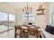 Bright dining room features deck access, modern lighting, and cozy bench seating at 140 Racer St, Bennett, CO 80102