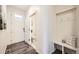Inviting entryway with coat rack and view of a half bathroom at 140 Racer St, Bennett, CO 80102