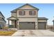 Two-story home with a 2-car garage, with a covered porch at 140 Racer St, Bennett, CO 80102