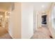 Hallway with carpet and white walls leading to other rooms at 140 Racer St, Bennett, CO 80102