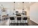 Kitchen island with pendant lighting and bar stool seating at 140 Racer St, Bennett, CO 80102