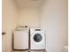 Bright laundry room features a Whirlpool washer and dryer at 140 Racer St, Bennett, CO 80102