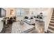Open-concept living room featuring hardwood floors, large windows, and modern decor at 140 Racer St, Bennett, CO 80102