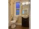 Bathroom featuring a toilet, a vanity with a sink, and a window for natural light at 3616 N Gilpin St, Denver, CO 80205