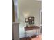 Console table with a decorative Eiffel Tower lamp and reflective mirror in a naturally lit interior hallway at 3616 N Gilpin St, Denver, CO 80205
