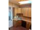 Bright kitchen with brick accent wall, stainless steel sink, and wooden cabinets at 3616 N Gilpin St, Denver, CO 80205