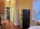 Kitchen featuring a stainless steel refrigerator, hardwood floors, and view to next room at 3616 N Gilpin St, Denver, CO 80205