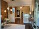 Open-concept living area featuring exposed brick, hardwood floors, decorative lighting, and large windows for ample natural light at 3616 N Gilpin St, Denver, CO 80205