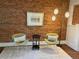 Living room featuring a brick wall, artwork, chairs, and modern lighting at 3616 N Gilpin St, Denver, CO 80205
