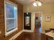 Living room featuring hardwood floors, brick accent wall, and natural light at 3616 N Gilpin St, Denver, CO 80205