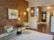 Comfortable living room with exposed brick, hardwood floors, and a cozy seating area at 3616 N Gilpin St, Denver, CO 80205