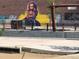Exterior mural depicting John Lewis on a brick wall with graffiti elements; an urban artistic tribute at 3616 N Gilpin St, Denver, CO 80205