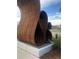 Sculpture of large metal curving forms arranged on a concrete base near an open public space at 3616 N Gilpin St, Denver, CO 80205