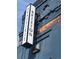 Exterior view of the 'Brixton Brasserie' sign, featuring a sleek vertical design and modern lighting against a textured building at 3616 N Gilpin St, Denver, CO 80205