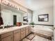 Elegant bathroom with a soaking tub and double vanities at 1663 Devils Point Pl, Highlands Ranch, CO 80126