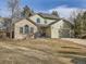 Two-story house with brick and siding, attached garage, and a spacious yard at 1663 Devils Point Pl, Highlands Ranch, CO 80126