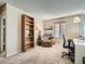 Bright home office features built-in shelving, comfortable seating, and a workspace at 1663 Devils Point Pl, Highlands Ranch, CO 80126