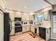 Galley kitchen with light cabinets, stainless steel appliances, and tile backsplash at 1663 Devils Point Pl, Highlands Ranch, CO 80126