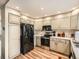 Kitchen with light cabinets, stainless steel appliances, and tile flooring at 1663 Devils Point Pl, Highlands Ranch, CO 80126