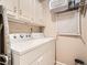 Laundry room with washer, dryer, cabinets, and shelving at 1663 Devils Point Pl, Highlands Ranch, CO 80126