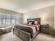 Bright main bedroom with a large bed and plenty of natural light at 1663 Devils Point Pl, Highlands Ranch, CO 80126