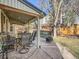 Covered patio with seating area, grill, and fenced backyard at 1663 Devils Point Pl, Highlands Ranch, CO 80126