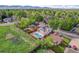 An aerial view of the home showcasing a well-maintained yard, neighborhood, and a glimpse of the mountain backdrop at 13270 W 65Th Ave, Arvada, CO 80004