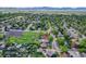An elevated aerial shot highlighting the property within a lush, green neighborhood at 13270 W 65Th Ave, Arvada, CO 80004