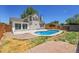 Beautiful backyard features a kidney shaped pool, concrete patio, and a privacy fence at 13270 W 65Th Ave, Arvada, CO 80004