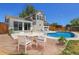 Backyard oasis boasting a pool, outdoor seating, a stone patio, and lush landscaping for tranquil relaxation at 13270 W 65Th Ave, Arvada, CO 80004