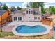 A private backyard with a kidney-shaped pool and concrete patio, perfect for outdoor relaxation and entertaining at 13270 W 65Th Ave, Arvada, CO 80004