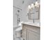 Bathroom featuring a tile backsplash, modern vanity, and bathtub with shower at 13270 W 65Th Ave, Arvada, CO 80004