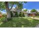 Charming two-story home with mature trees, manicured lawn, and an attached two car garage at 13270 W 65Th Ave, Arvada, CO 80004