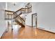 Bright foyer with hardwood floors, grand staircase, and natural light at 13270 W 65Th Ave, Arvada, CO 80004
