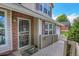 Charming front porch with decorative screen door, brick accents, and ample natural light at 13270 W 65Th Ave, Arvada, CO 80004