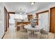 Open kitchen with island seating, modern appliances, and a bright dining area at 13270 W 65Th Ave, Arvada, CO 80004