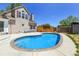 Backyard features a well-maintained pool, a spacious concrete patio, and a lush green lawn at 13270 W 65Th Ave, Arvada, CO 80004