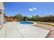 Backyard features a well-maintained pool, a spacious concrete patio, and a privacy fence at 13270 W 65Th Ave, Arvada, CO 80004