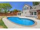 Backyard pool area has concrete edging, a privacy fence, and a view of the home at 13270 W 65Th Ave, Arvada, CO 80004