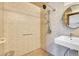 Accessible walk-in shower with neutral tiles, modern fixtures, and convenient grab bars, designed for comfort and ease of use at 13270 W 65Th Ave, Arvada, CO 80004