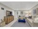 Basement living room with neutral colors, entertainment center, and comfortable seating at 549 N Ogden St, Denver, CO 80218