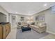 Cozy basement living room features neutral colors, comfortable couches, and a dark blue ottoman at 549 N Ogden St, Denver, CO 80218