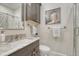 Modern bathroom featuring a vanity with marble countertop, white subway tile, and glass-enclosed shower at 549 N Ogden St, Denver, CO 80218