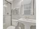 Modern bathroom featuring a pedestal sink, toilet, and glass-enclosed shower with white tile at 549 N Ogden St, Denver, CO 80218