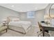 Cozy bedroom with white linens, modern side table, and desk area, perfect for relaxation and work at 549 N Ogden St, Denver, CO 80218