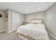 Neutral toned bedroom with a full-sized bed and chair, and a simple closet at 549 N Ogden St, Denver, CO 80218